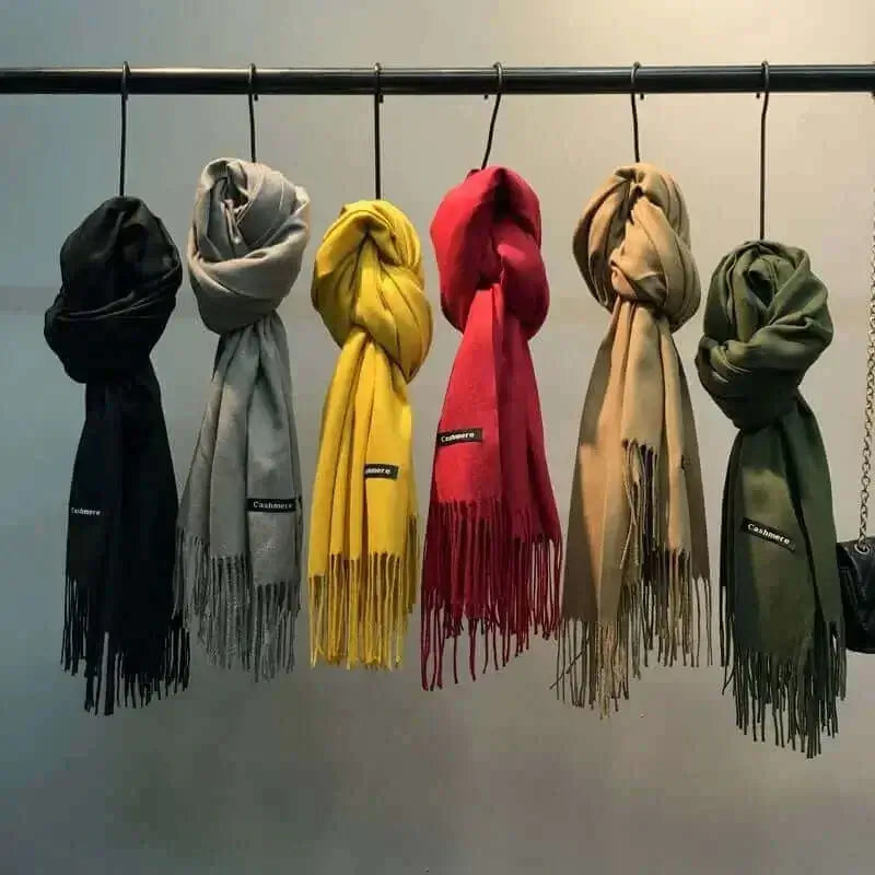 colorful scarves hanging on a rack, showcasing budget-friendly gifts for her options.