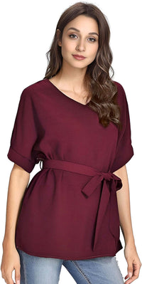 Woman wearing a maroon batwing casual blouse with a V-neck and a belt, styled for summer fashion.