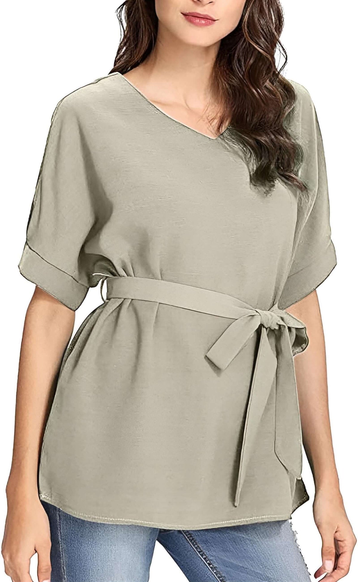 A woman models a batwing casual blouse in a soft gray hue, featuring a V-neck and belted waist.
