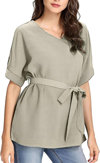 A woman models a batwing casual blouse in a soft gray hue, featuring a V-neck and belted waist.