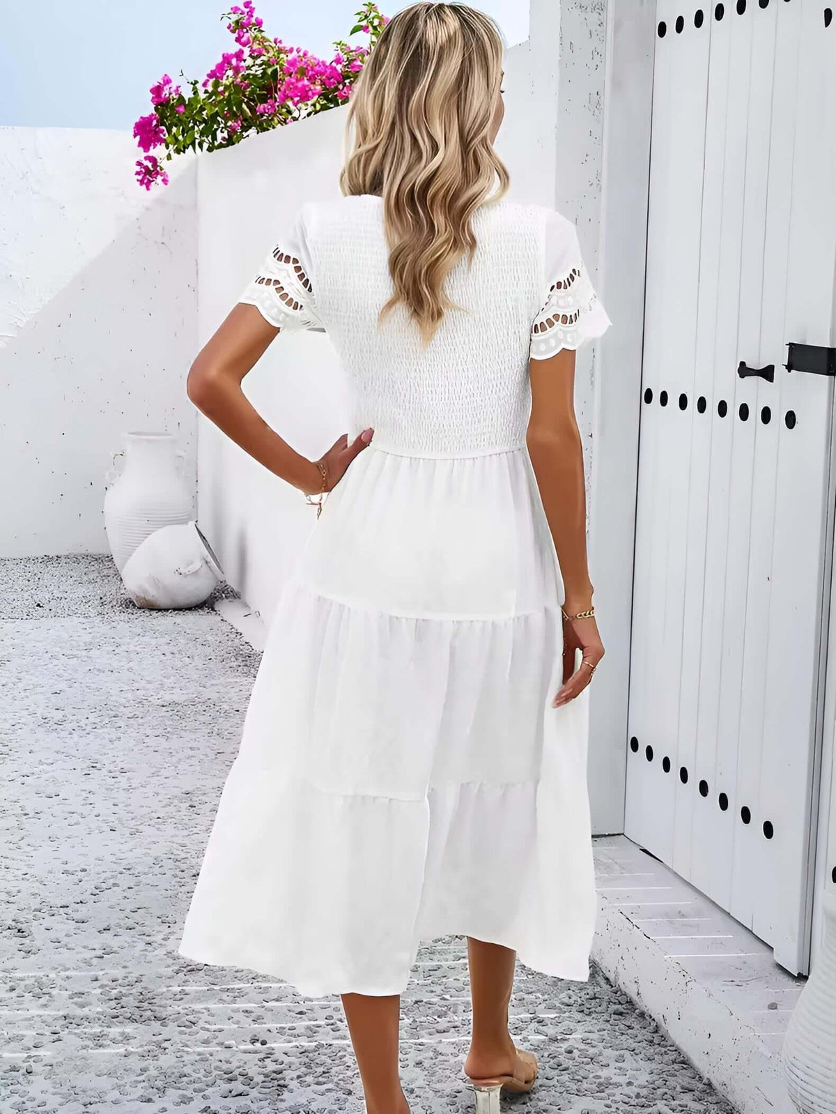 Hallow Eyelet Sleeve Dress - Back view of a woman in a white tiered midi dress with eyelet sleeves, perfect for spring summer.