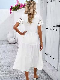 Hallow Eyelet Sleeve Dress - Back view of a woman in a white tiered midi dress with eyelet sleeves, perfect for spring summer.