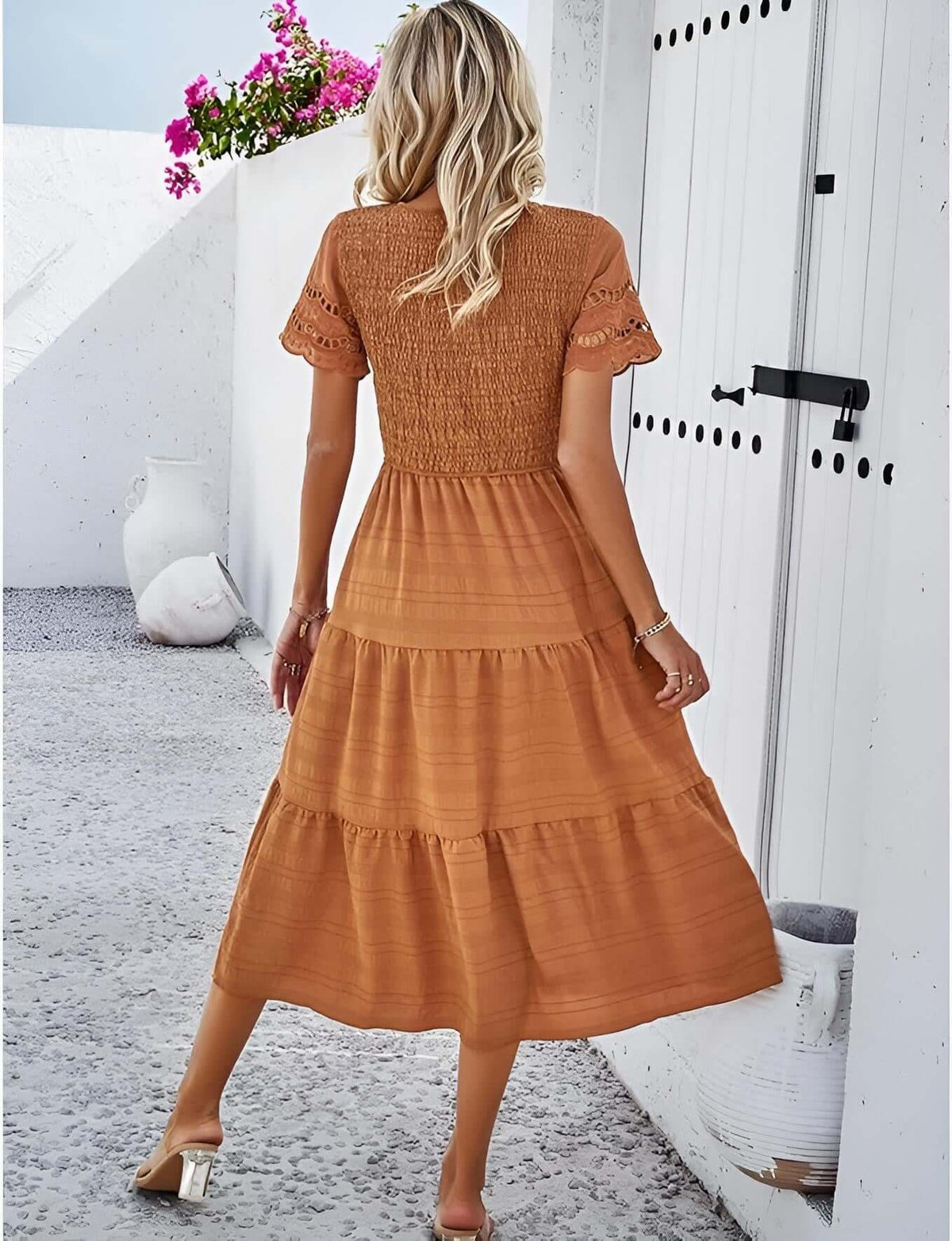 Hallow Eyelet Sleeve Dress - Back view of women’s boho fashion featuring a ruffled tiered hem in solid orange color.