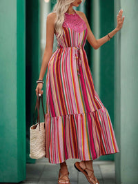 Multi Pink Stripes Maxi Dress worn by a model in a vibrant striped pattern, showcasing a halter neckline and ruffle detailing.