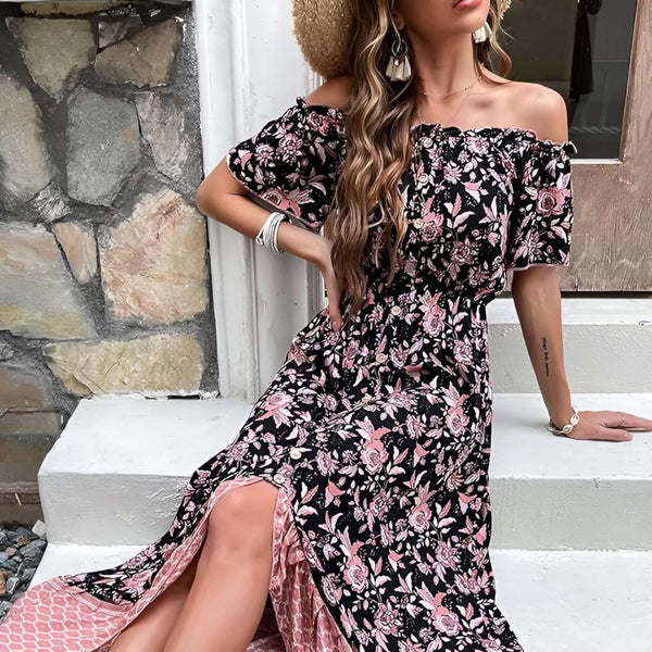 Woman wearing a bohemian off shoulder maxi dress with floral print, sitting on steps in a stylish pose.