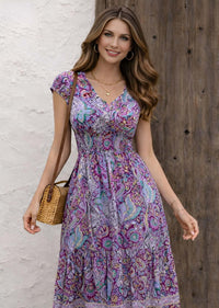 Boho midi dress in vibrant purple floral pattern, perfect for casual outings or special occasions.
