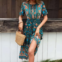 Woman wearing a turquoise bohemian floral midi dress with floral print and short sleeves, holding a woven basket.