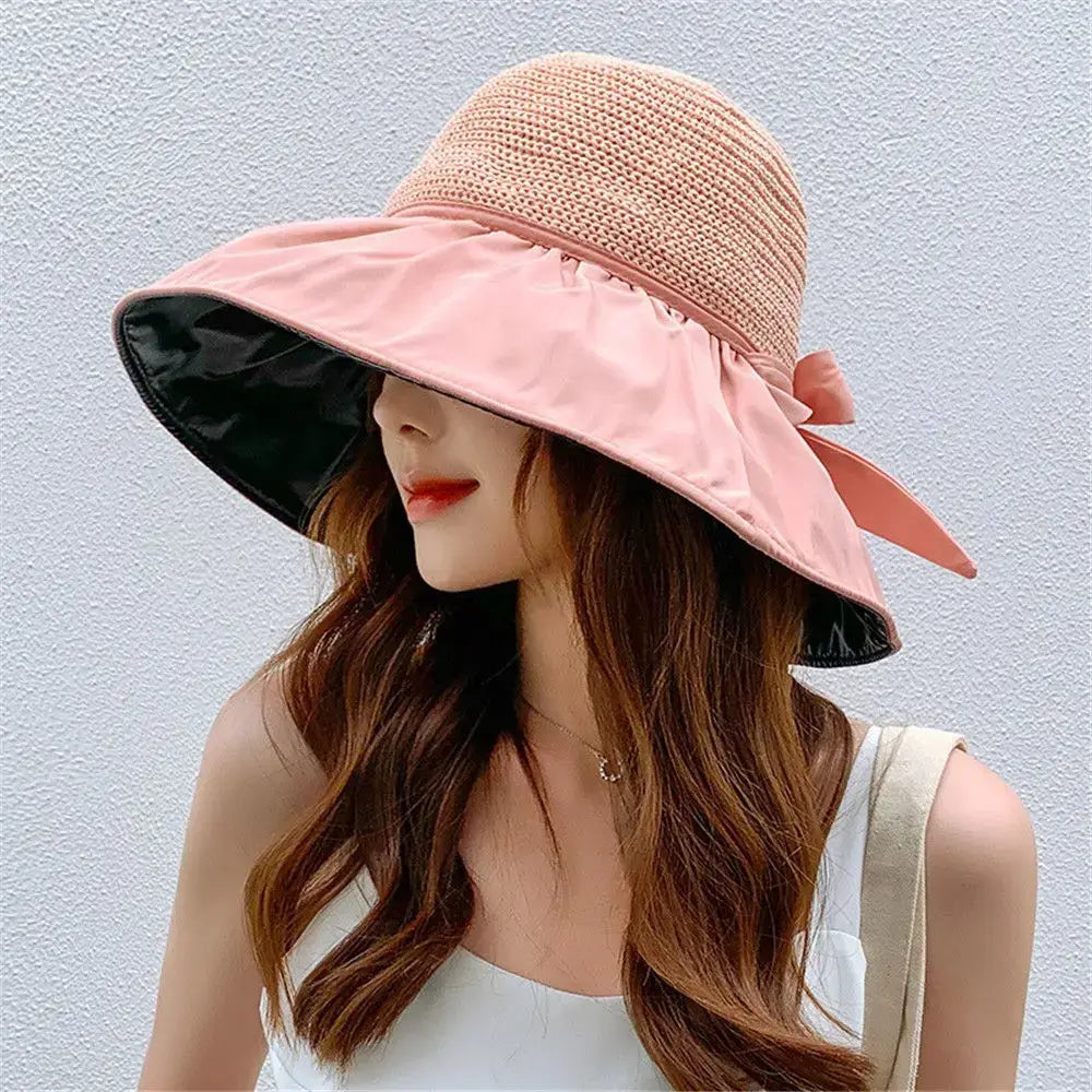 Women's UPF sun protection hat with a wide brim, decorative bow, and adjustable chin strap for outdoor summer use.