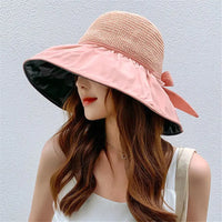 Women's UPF sun protection hat with a wide brim, decorative bow, and adjustable chin strap for outdoor summer use.