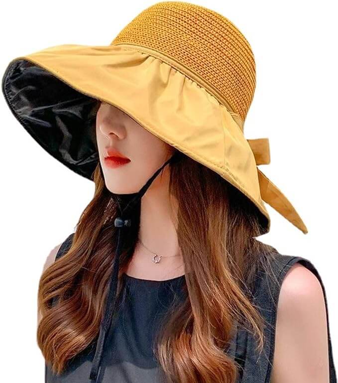 Women wearing a UPF sun protection hat with wide brim and decorative ribbon, ideal for summer outdoor activities.