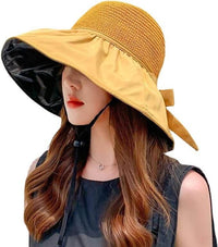 Women wearing a UPF sun protection hat with wide brim and decorative ribbon, ideal for summer outdoor activities.