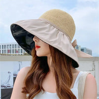 Women's UPF sun protection hat with wide brim and decorative bow, perfect for summer beach outings.